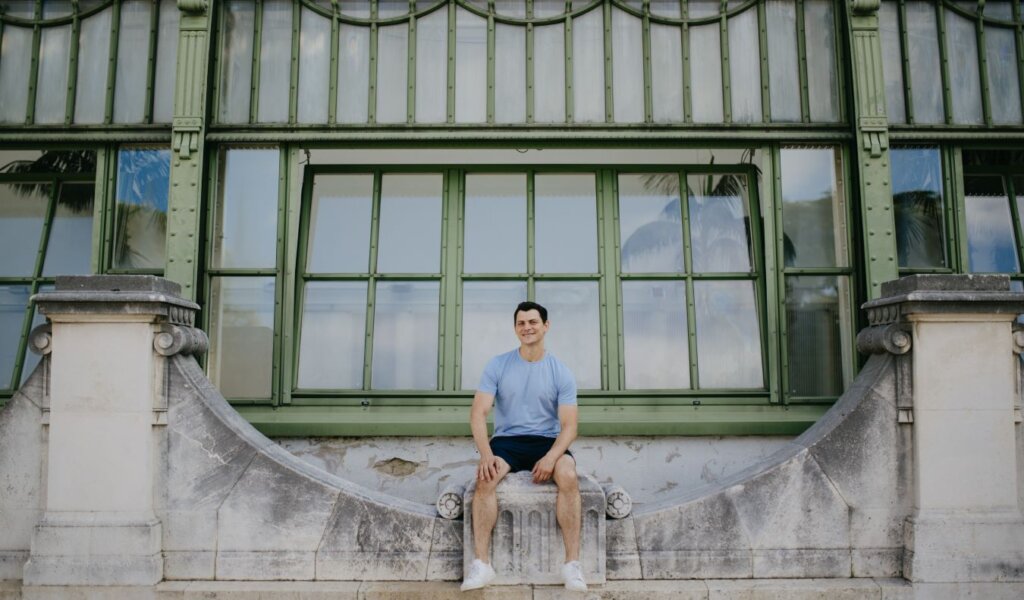 Nomadic Matt sitting on a bridge in Vienna, Austria