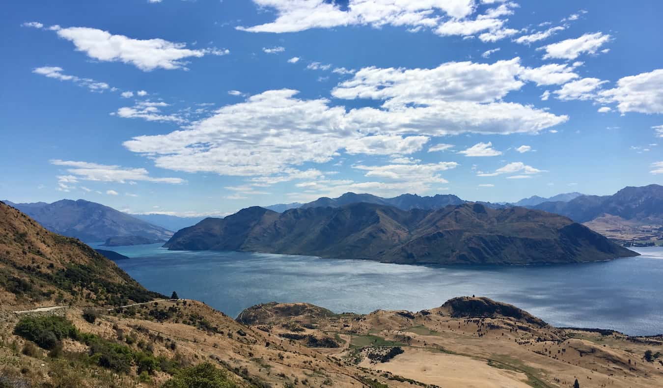 A beautiful, sunny day with blue skies in stunning New Zealand, with mountains and water filling the distance