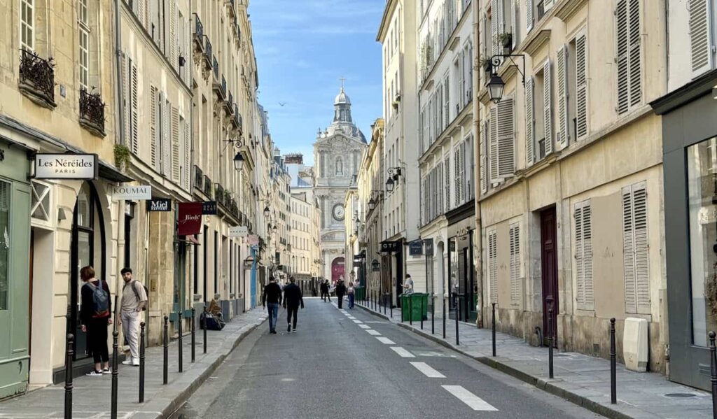 A sunny day in Paris on a quiet street lined by historic buildings